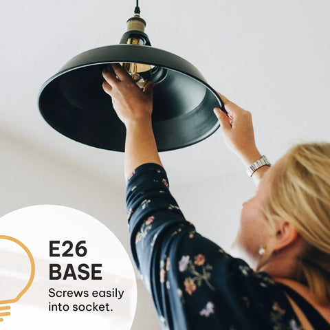 Person installing Vintage Edison Light Bulbs 60W 4 Pack ST58 Squirrel Filament Clear Glass E26 E27 Dimmable Warm White 2100K