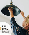Person installing Vintage Edison Light Bulbs 60W E26 E27 Base 2100K Dimmable ST58 Style Warm Glow Squirrel Filament 6 Pack