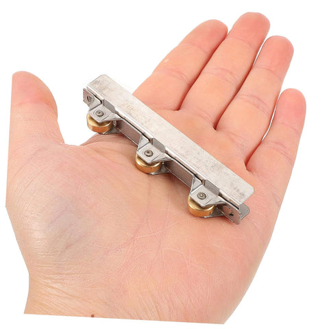 Quiet Glass Door Sliding Roller Wheel Set With Silent Bearing Pulleys in hand, showing size and brass/steel materials.