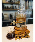 Premium Glass Ice Drip Coffee Maker For Next Level Cold Brew Delivery And Lightning Fast Drink Chilling serves up brewed coffee in a glass carafe.