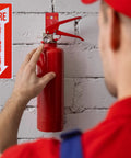 Person installing 2 Pack Fire Extinguisher Holder And 4 Sign Stickers on a brick wall, heavy duty mount for 5 to 20 lb extinguishers