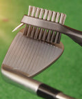Three In One Golf Gear Kit With Microfiber Waffle Towel Clip, Golf Club Brush Groove Cleaner And Divot Tool With Marker For Men And Women Ideal Gift For Golfers Of All Levels And Ages showing brush cleaning club.
