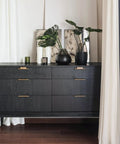 Thick Black Peel And Stick Wallpaper Roll Featuring Hella Durable Self Adhesive PVC Material For Quick Interior Wall Covering With Zero Residue Guarantee on a stylish black dresser with decorative items.