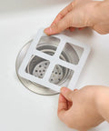 10 Piece Pack Disposable Shower Drain Catcher 3.9 Inch Silver Mesh Filter For Tub And Sink keeps drain clear during hair cleanup.