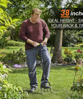 Man using a 38-inch manual spike lawn aerator with four 3.5 inch solid steel spikes for compacted soils and lawns.