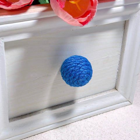 Close-up of a blue jute rope knob on a white cabinet, part of 6 Pack Jute Rope Cabinet Knobs Set 1.26 Inch Round Wood Knobs For Kitchen Cabinets