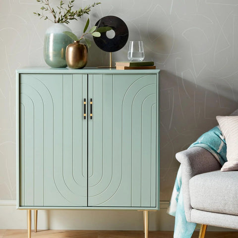 Modern cabinet with geometric design, decorated with vases and books, in a living room setting