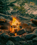 Campers using Double Pie Iron Sandwich Maker For Camping With Cast Iron Campfire Pie Cooker over open fire in forest setting.