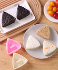 Triangle Rice Ball Molds 2 Pack Large Do It Yourself Sushi Makers Kit For Lunch Bento Easy Rice Ball Mold With Paddle on table