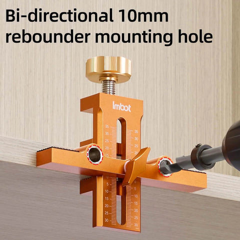 Orange aluminum cabinet door mounting jig in use, featuring visible dual-hole locator for precise drilling on a cabinet.
