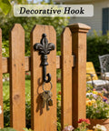 Top Shelf Single Piece Heavy Duty Cast Iron Wall Hook With Screws Vintage Coat Hanger Organizer For Scarves Bags Towels Keys Cap Rustproof Badass Home Decor Accessory mounted on wooden fence holding keys.