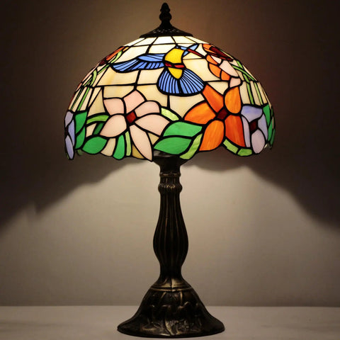Stained Glass Tiffany Style Hummingbird Table Lamp 12 Inch Shade And 18 Inch Tall Bedside Desk Reading Light Antique Green Bronze Base UL Listed Perfect Decor For Bedroom Living Room Home Office S101 Series with colorful flower pattern on shade.