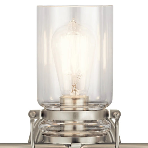 Close-up of clear glass shade on Brinley 24-Inch Three-Light Vanity Light In Brushed Nickel With Farmhouse Chic design