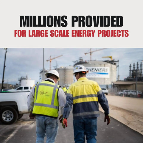 Two workers in safety vests and helmets at a construction site for large energy projects