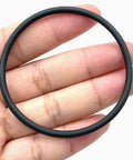 Hand holding Engine Camshaft Adjuster Magnet Seal 52X3 mm WHT007212B for VW Audi models, black rubber