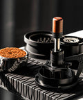 Hella Smooth 58mm Wdt Distribution Tool For Espresso Bars featuring ten adjustable needles on a black base with walnut grip.