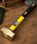 Two Pound Brass Head Sledge Hammer With Fiberglass Handle, Workhorse Impact Tool For Demolition, on a wooden surface.