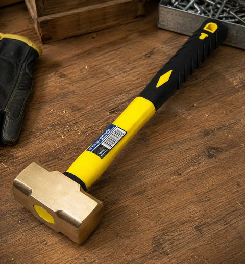 Two Pound Brass Head Sledge Hammer With Fiberglass Handle, Workhorse Impact Tool For Demolition, on a wooden surface.