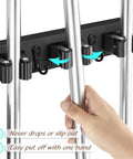 Wall Mount Mop And Broom Holder With Four Slots And Four Hooks For Quick Easy Gear Organization In Pantry Closet And Laundry Room Heavy Duty Black Rustic Wood Tool Organizer For Indoor Or Outdoor Use, hand placing mop