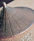 Close-up of the lid of a Retro Styled Sealed Ceramic Jar For Loose Tea And Coffee Beans showing textured finish and design.