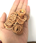 Hand holding Copper Washer Set Go-To For Marine Equipment And Heavy Duty Machinery, 50 Pc M18 Copper Sealing Washers Kit, Flat Washers Assortment