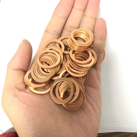 Hand holding Copper Washer Set Go-To For Marine Equipment And Heavy Duty Machinery, 50 Pc M18 Copper Sealing Washers Kit, Flat Washers Assortment