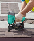 Person using CN45C 15 Degree Roofing Nailer Pneumatic Coil Nailer for shingles on rooftop, showing 120 nail capacity.
