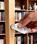 Person using Heavy Duty Clear Plastic Shims And Leveling Wedges For Wobbly Toilets Furniture And Appliances Trim To Fit, stabilizing furniture.