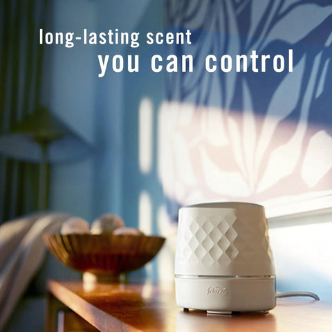 Plug In Scent Booster Starter Kit With Ocean Refills, Black Oil Diffuser Air Freshener on table, soft room lighting