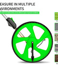 Distance Measuring Wheel With 10K Ft Range, showing green wheel and multiple terrain compatibility, highlighting rubber tire and handle.