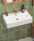 CHIKESI 24"x14" Wall Mount Sink, White Rectangular with faucet on a green tiled wall in a modern bathroom.
