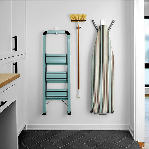 Wall showing Ten Pound Extra Large Heavyweight Wall Hooks With Adhesive Strips holding a ladder, broom, and ironing board.