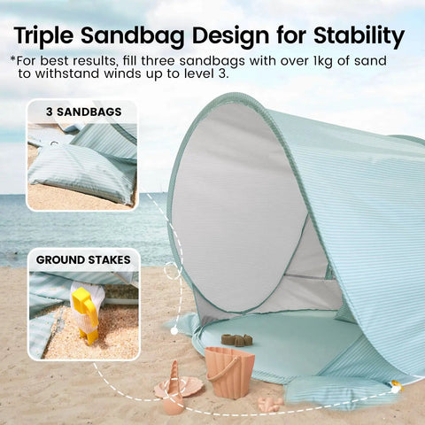 Pop Up Baby Beach Tent with UV Protection showing triple sandbag design and ground stakes for stable anchoring on sand.