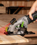 GALAX PRO 4A circular saw, side view with laser guide cutting wood; 4-1/2" 24T blade, red laser line.