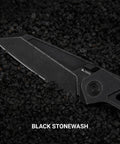 Black titanium pocket knife with M390 powder steel blade, thumb hole, and stonewash finish on rough black stones