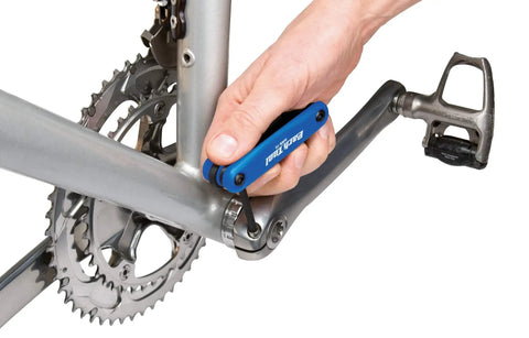Hand using Fold Up Hex Wrench Set With 1.5mm Through 6mm Hex Keys Crafted From Industrial Tool Steel on bicycle crank arm.