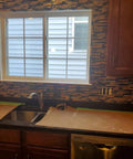 Interlocking Metallic Glass Tile Mosaic In Rose Gold Silver And Ink Blue For Kitchen Backsplash installed around a window.