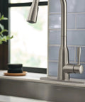 Top Shelf Stainless Steel Pull Down Kitchen Faucet Featuring One Handle High Arc Design with smooth spray hose in kitchen.