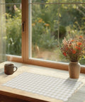 Scalloped Beige Checkered Gingham Desk Pad Large Mouse Pad For Keyboard And Computer, Cozy Cottagecore Vibe Vintage Rustic Aesthetic Office Mat, 31 By 15.7 Inches on a wooden desk by a window.