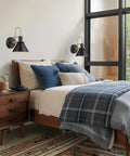 Bedroom with set of 2 industrial wall sconce lights modern 1 light vanity fixtures in matte black with brushed gold interior.