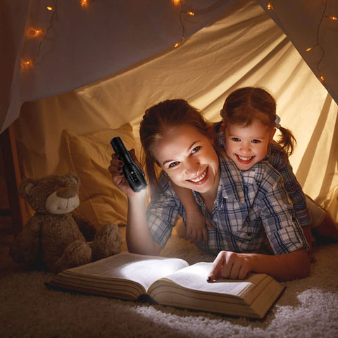 Two Pack Ultra Bright 1000 Lumen LED Flashlights used during indoor reading, woman holding flashlight, cozy atmosphere