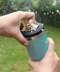 Hands holding 4 In 1 Insulated Stainless Steel Can Insulator That Fits Standard And Slim 12 Oz Cans And Beer Bottles Doubles As A 12 Oz Insulated Tumbler For Outdoor Adventures, lake blue, with beer spraying outdoors.