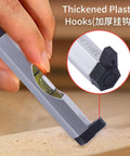 Close-up of Legit 3 Pack Aluminum Bubble Line Level String Tool with thickened plastic hooks in use on a wooden surface.