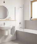 Modern bathroom with Eurosmart Single Hole Bathroom Faucet Single Handle Chrome Finish 1.2 GPM Flow Includes Nylon Braided Hoses and Drain Assembly Works On 1 Hole Or 3 Hole Sinks With Deck Plate Angled Aerator Drip Free on white sink, grey tiles, and bathtub with window view in neutral tones.