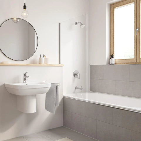 Modern bathroom with Eurosmart Single Hole Bathroom Faucet Single Handle Chrome Finish 1.2 GPM Flow Includes Nylon Braided Hoses and Drain Assembly Works On 1 Hole Or 3 Hole Sinks With Deck Plate Angled Aerator Drip Free on white sink, grey tiles, and bathtub with window view in neutral tones.