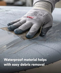 Hand using Wetordry Sandpaper Sheets 800 Plus Grit 9 In By 11 In Pack Of 50 for auto sanding on wet car surface with gloves.