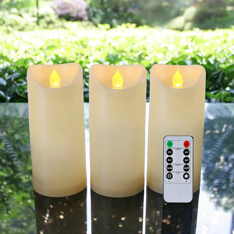 Outdoor Waterproof Flameless Candles With Timers And Remote Control For Porch And Patio Vibe No Mess Cleanup Realistic Wax Look Battery Operated LED Plastic Ivory Candles 3 By 7 Inch Set Of 3 on glass table