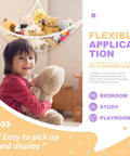 Child holding stuffed animal with a Stuffed Animal Net Hammock for Plush Toys, Corner Organizer for Kids Room Decor in the background
