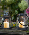 Eight-Hour Smokeless Dripless Ivory Votive Candles Bulk Pack Of 72 Sticks, 1.25 Inch in lantern holders on outdoor table