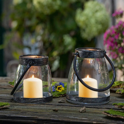Eight-Hour Smokeless Dripless Ivory Votive Candles Bulk Pack Of 72 Sticks, 1.25 Inch in lantern holders on outdoor table